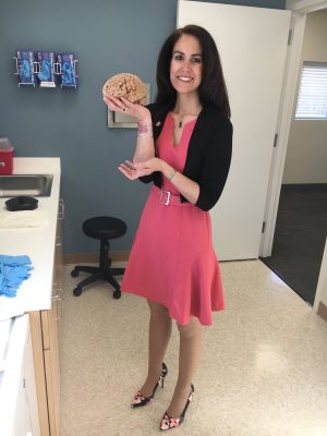 Woman holding a model of the brain representing firefighter mental health 