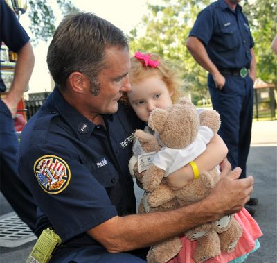 Fire fighter comforts child