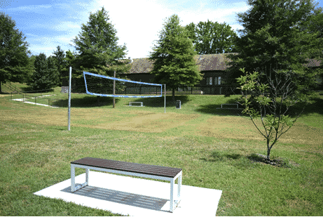 Sports net and a bench in the back of the IAFF Center of Excellence building