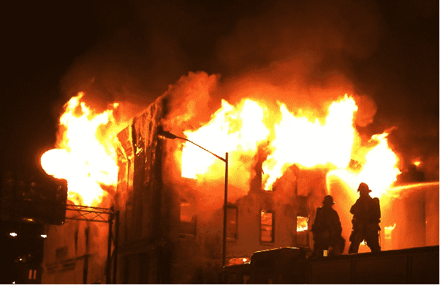 Fire fighters getting ready to put out the fire of a burning building