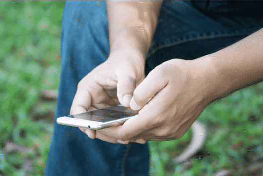 Closeup of a fire fighter on his phone about to call a suicide hotline