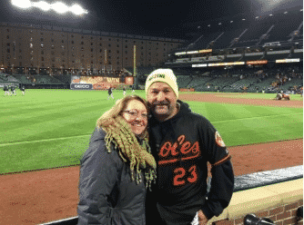 Bill Allenbaugh with his wife on a baseball field