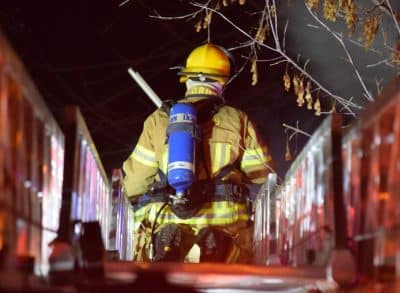 Fire fighter on a ramp about to put out a fire