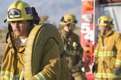 fire fighter setting up hose