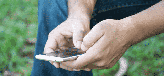 Person struggling with mental health on his phone to get help