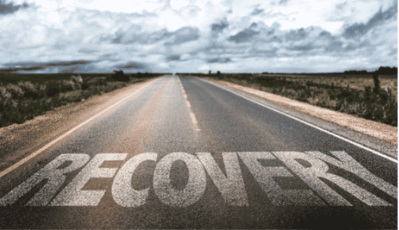 An open road with the word recovery painted on it