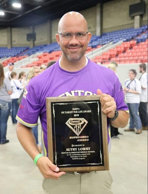 autry lowry smiling and holding award